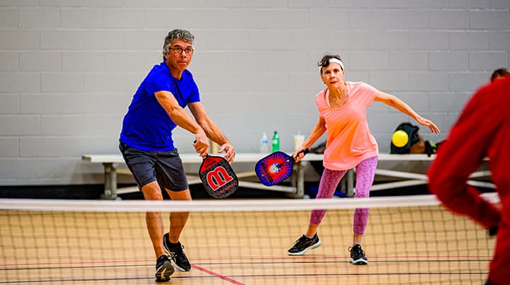 Two people playing social pickleball